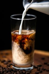 Ice coffee with lots of milk being added