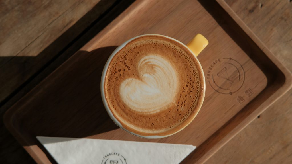 A latte with a love heart shape made out of the milk